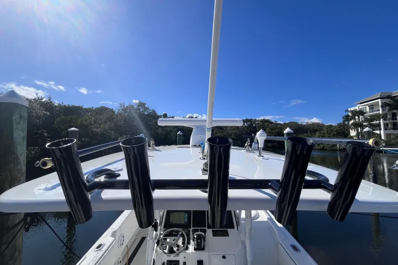 Yacht Photos Pics 2008 Intrepid 370 Cuddy boat with rod holders, docked under clear blue sky.