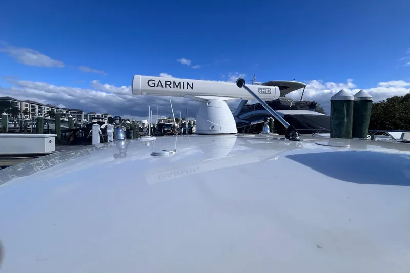  Yacht Photos Pics 2008 Intrepid 370 Cuddy with Garmin radar, docked under clear blue sky.