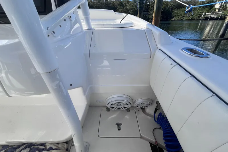  Yacht Photos Pics 2008 Intrepid 370 Cuddy boat interior with seating and speakers, docked by the water.