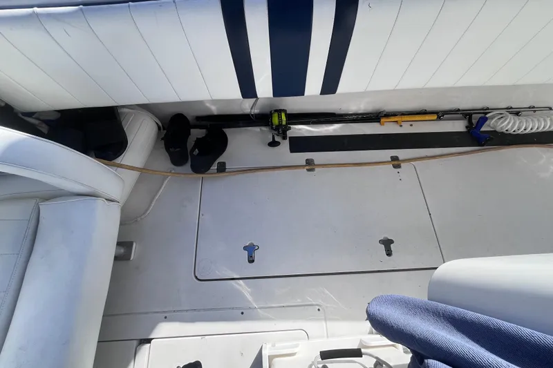  Yacht Photos Pics 2008 Intrepid 370 Cuddy boat interior with fishing gear and white seating.