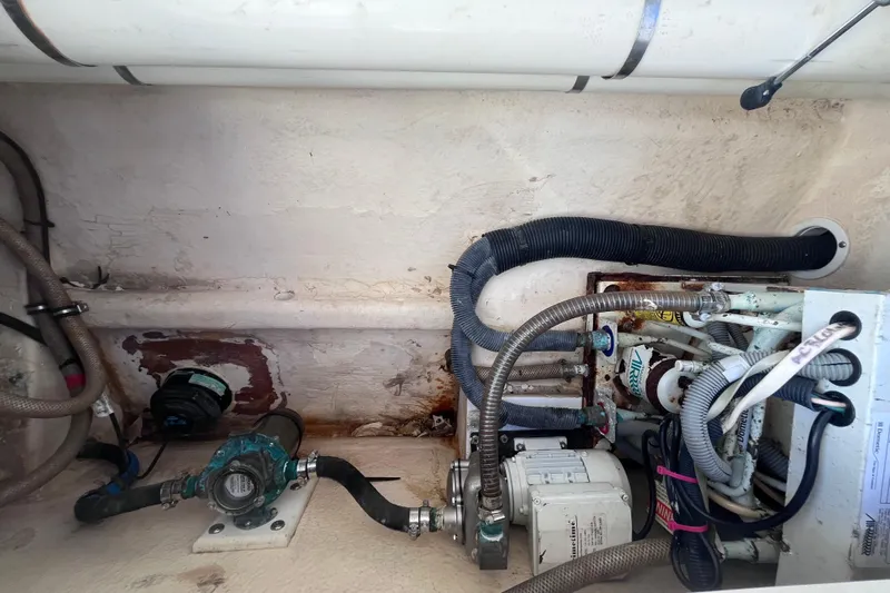  Yacht Photos Pics Engine compartment of a 2008 Intrepid 370 Cuddy boat, showing hoses and mechanical components.