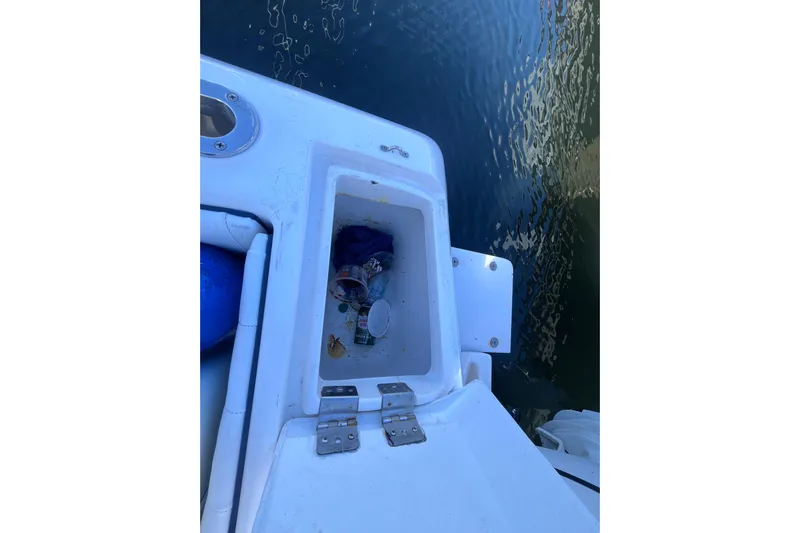  Yacht Photos Pics Open storage compartment on 2008 Intrepid 370 Cuddy boat, near water.