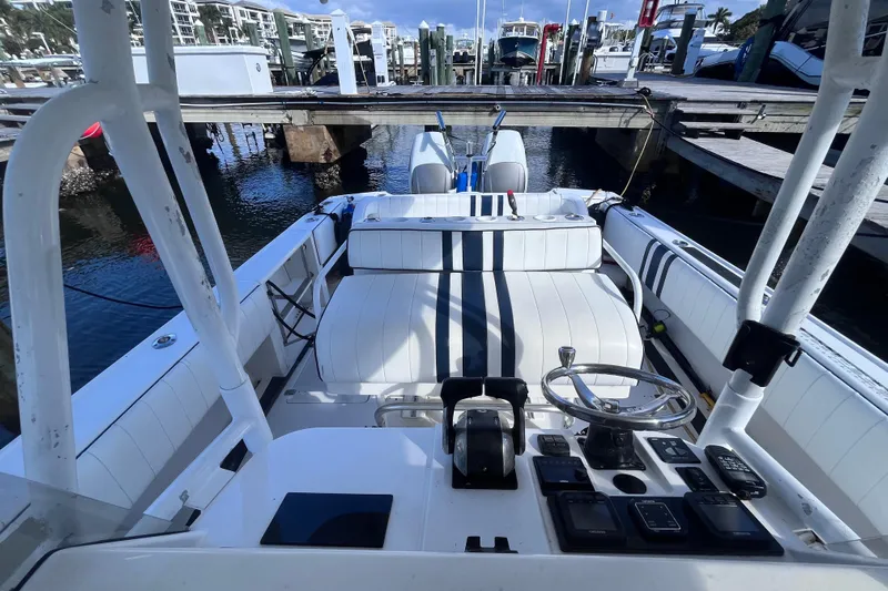  Yacht Photos Pics 2008 Intrepid 370 Cuddy boat interior with steering wheel and control panel.