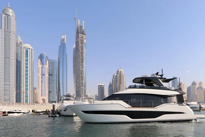  Yacht Photos Pics 2024 Cranchi Sessantasette 67 yacht in a modern city marina with skyscrapers.