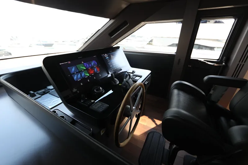  Yacht Photos Pics Helm of 2024 Cranchi Sessantasette 67 yacht with modern controls and steering wheel.
