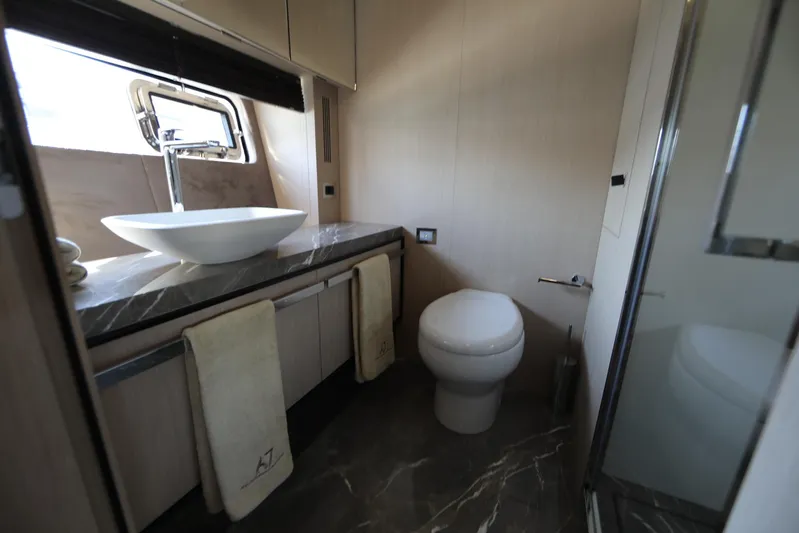  Yacht Photos Pics Luxurious bathroom in 2024 Cranchi Sessantasette 67 yacht with modern sink and toilet.