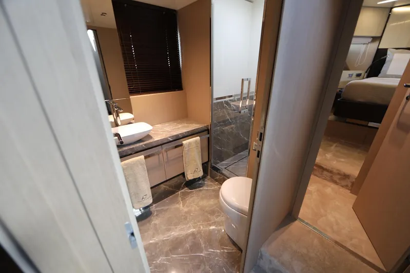  Yacht Photos Pics Luxurious bathroom interior of 2024 Cranchi Sessantasette 67 yacht, featuring modern fixtures and elegant design.