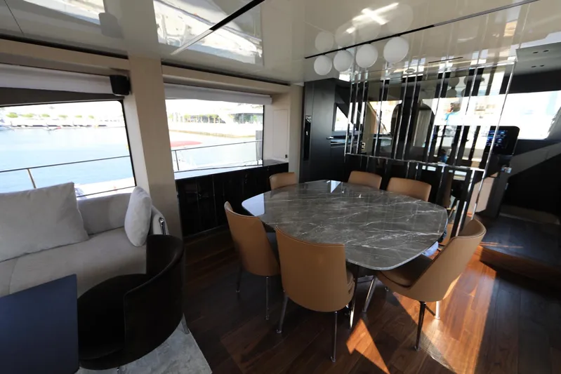  Yacht Photos Pics Luxurious interior of 2024 Cranchi Sessantasette 67 yacht with elegant dining area and panoramic windows.