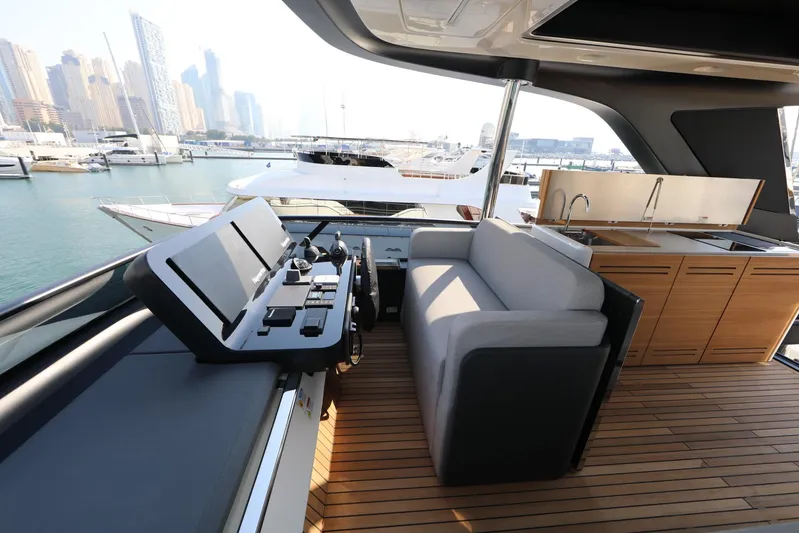  Yacht Photos Pics Luxurious 2024 Cranchi Sessantasette 67 yacht interior with modern helm and seating area.
