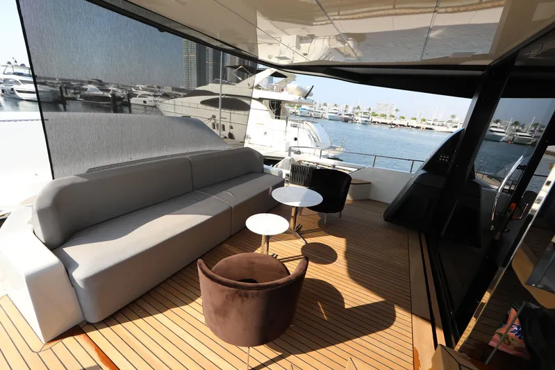  Yacht Photos Pics Luxurious Cranchi Sessantasette 67 yacht interior, featuring elegant seating and scenic marina views.