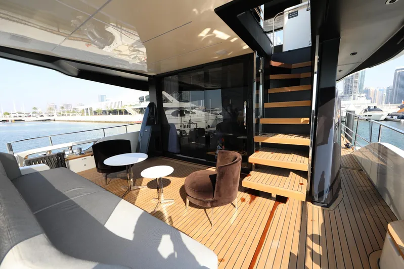  Yacht Photos Pics Luxurious deck of 2024 Cranchi Sessantasette 67 yacht with modern seating and staircase.