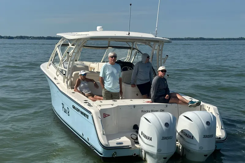 Plan B Yacht Photos Pics 2019 Grady-White Freedom 307 boat with passengers on calm water, featuring twin Yamaha engines.