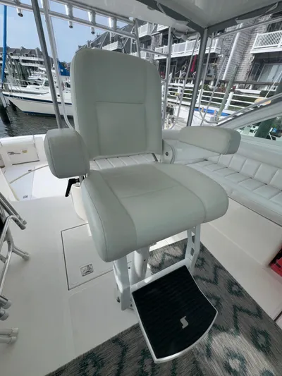 Land Ho Yacht Photos Pics Captain's chair on 2007 Cabo 40 Express yacht, docked at marina.