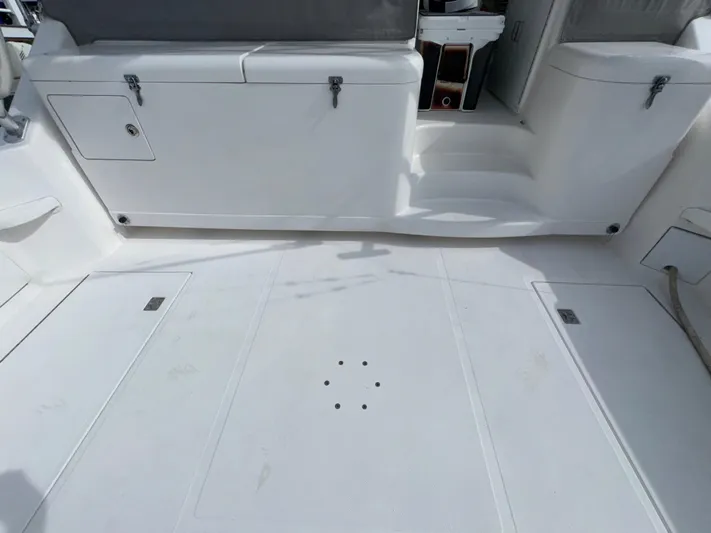 Land Ho Yacht Photos Pics 2007 Cabo 40 Express boat deck with storage compartments and seating area.