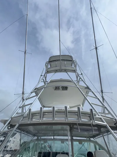 Land Ho Yacht Photos Pics 2007 Cabo 40 Express boat tower against a cloudy sky.