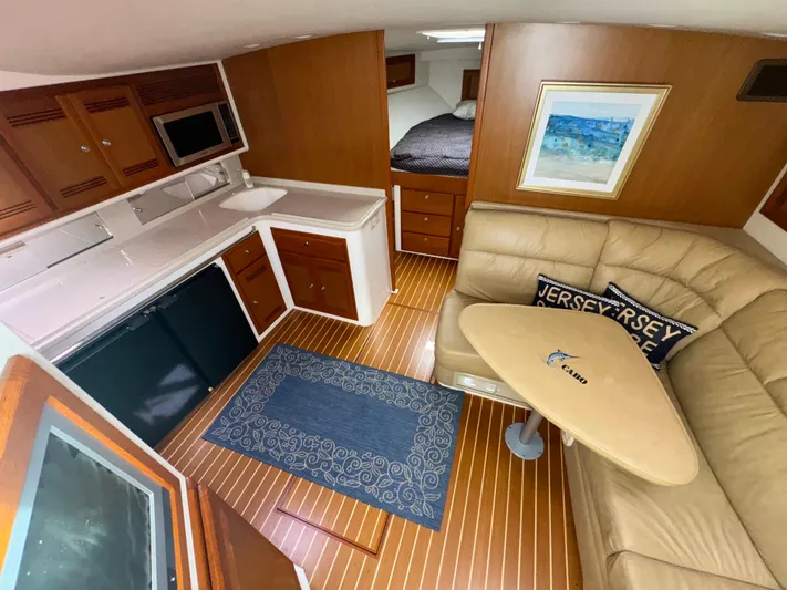 Land Ho Yacht Photos Pics Interior of 2007 Cabo 40 Express yacht with kitchen, seating, and sleeping area.