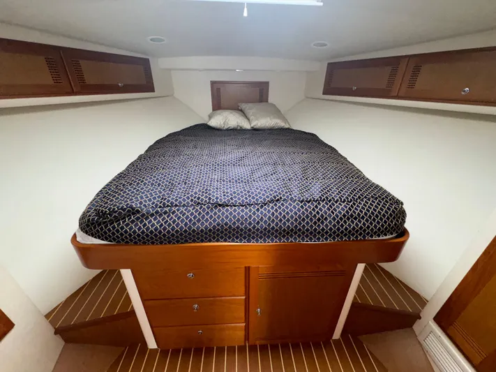 Land Ho Yacht Photos Pics 2007 Cabo 40 Express cabin with bed, wooden storage, and cozy interior design.