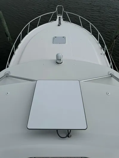 Land Ho Yacht Photos Pics Bow view of 2007 Cabo 40 Express boat, featuring sleek design and railing.