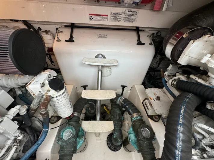 Land Ho Yacht Photos Pics Engine compartment of a 2007 Cabo 40 Express boat, showing various mechanical components and hoses.