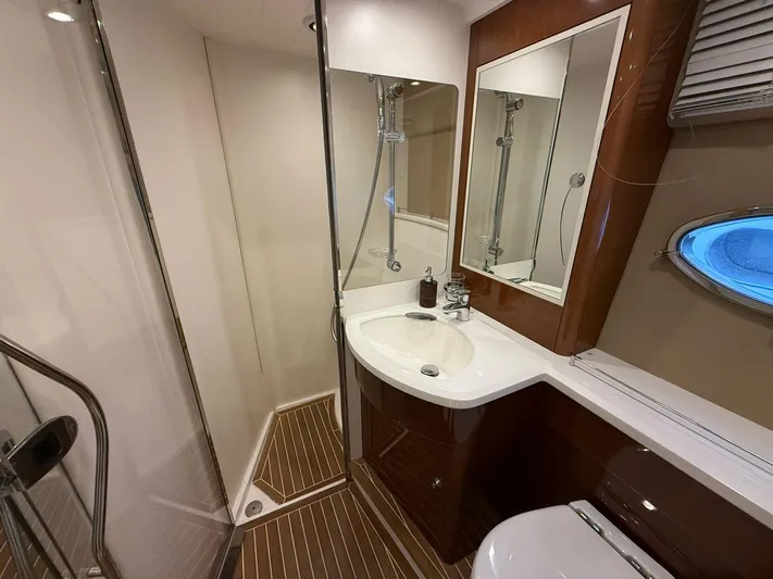  Yacht Photos Pics Luxurious bathroom in 2009 Princess V58 yacht with modern fixtures and wooden accents.