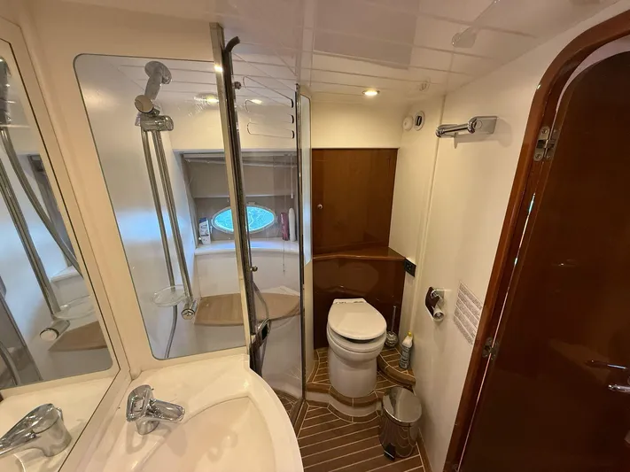  Yacht Photos Pics Luxurious bathroom in 2009 Princess V58 yacht with shower, sink, and toilet.