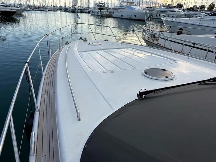  Yacht Photos Pics 2009 Princess V58 yacht deck with sleek design, docked in marina.