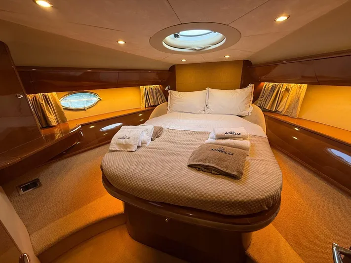  Yacht Photos Pics Luxurious cabin interior of 2009 Princess V58 yacht with cozy bedding and ambient lighting.