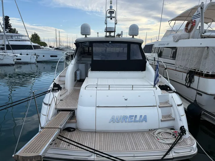  Yacht Photos Pics 2009 Princess V58 yacht docked at marina, rear view with "Aurelia" name visible.