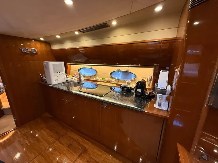  Yacht Photos Pics Luxurious kitchen interior of 2009 Princess V58 yacht with modern appliances and wood finish.