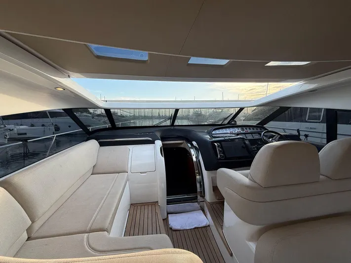  Yacht Photos Pics Luxurious interior of a 2009 Princess V58 yacht with plush seating and modern dashboard.