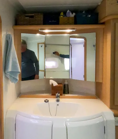 Bleu Lagoon Yacht Photos Pics Bathroom interior of a 2012 Lagoon 421 catamaran with mirror and sink.