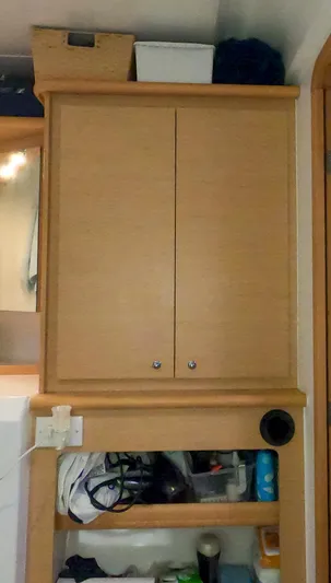 Bleu Lagoon Yacht Photos Pics Wooden cabinet with shelves in a 2012 Lagoon 421 boat interior.