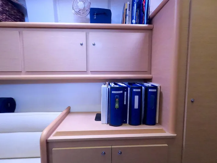 Bleu Lagoon Yacht Photos Pics Interior of 2012 Lagoon 421 yacht with shelves and blue binders.