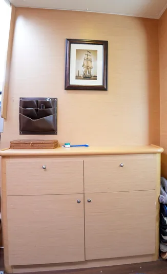 Bleu Lagoon Yacht Photos Pics Interior of 2012 Lagoon 421 yacht with framed ship artwork and wooden cabinetry.