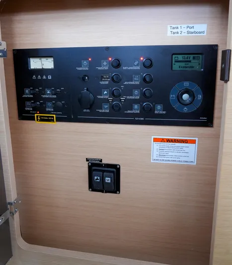 Bleu Lagoon Yacht Photos Pics Electrical control panel of a 2012 Lagoon 421 catamaran with various switches and indicators.