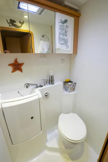 Bleu Lagoon Yacht Photos Pics Compact bathroom in 2012 Lagoon 421 yacht with modern fixtures and nautical decor.