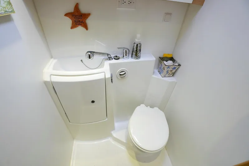 Bleu Lagoon Yacht Photos Pics Compact bathroom in a 2012 Lagoon 421 yacht, featuring a sink and toilet.