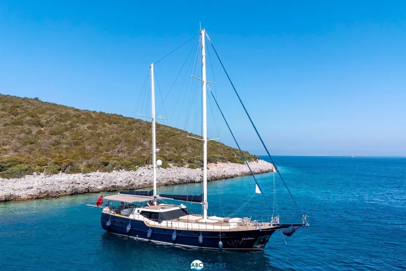 Cİca Sultan Yacht Photos Pics Sailing yacht Ark Yat 24M, 2014 model, anchored near a rocky coastline.