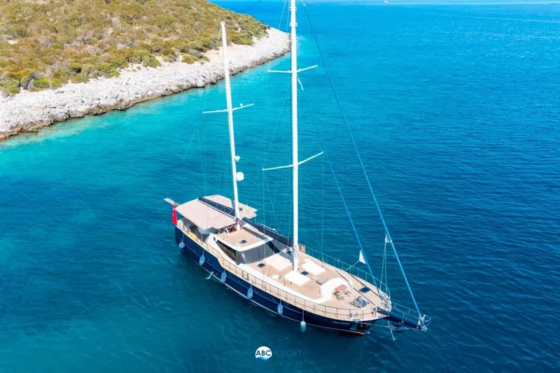 Cİca Sultan Yacht Photos Pics Luxurious 2014 Ark Yat 24M yacht anchored in clear turquoise waters near a rocky coastline.