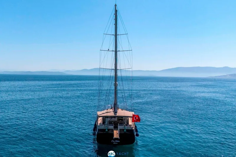 Cİca Sultan Yacht Photos Pics Sailing yacht Ark Yat 24M, 2014 model, on serene blue sea with distant mountains.
