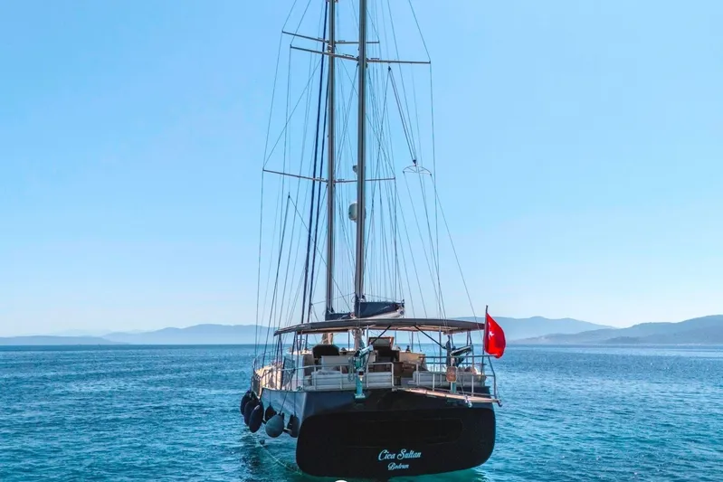 Cİca Sultan Yacht Photos Pics Sailing yacht Ark Yat 24M, 2014 model, on serene blue waters with distant mountains.