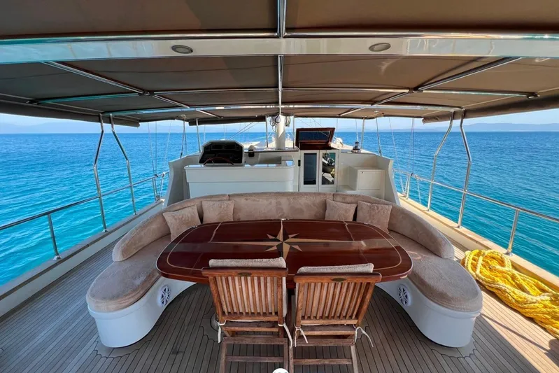 Cİca Sultan Yacht Photos Pics Luxurious Ark Yat 24M yacht deck with elegant seating, overlooking serene blue ocean waters.