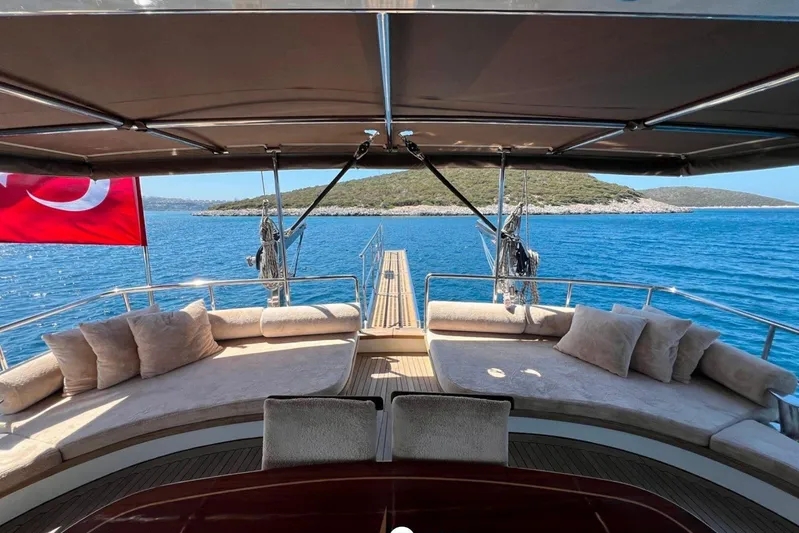 Cİca Sultan Yacht Photos Pics Luxurious Ark Yat 24M yacht deck with plush seating, Turkish flag, and scenic ocean view.