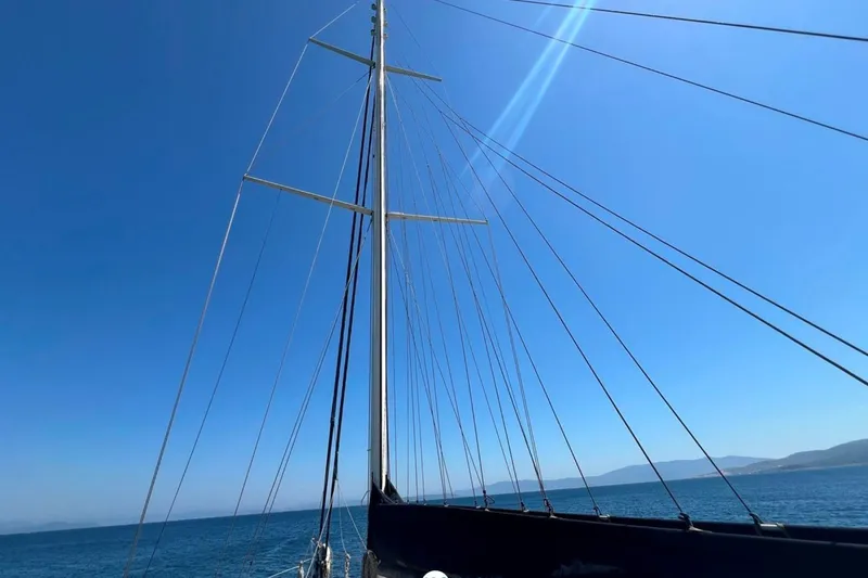 Cİca Sultan Yacht Photos Pics Sailing yacht Ark Yat 24M, 2014 model, with tall mast against clear blue sky.