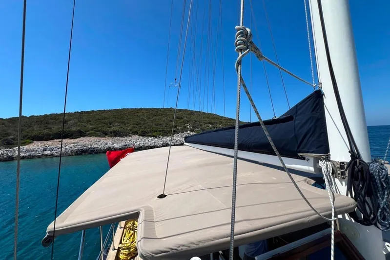 Cİca Sultan Yacht Photos Pics Sailing yacht Ark Yat 24M, 2014, anchored near rocky coastline under clear blue sky.