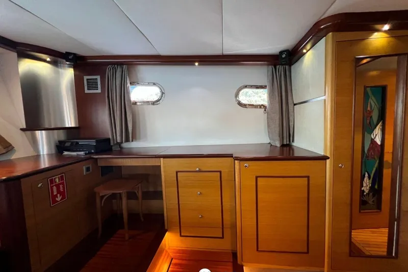 Cİca Sultan Yacht Photos Pics Luxurious interior of 2014 Ark Yat 24M yacht with wooden cabinetry and porthole windows.