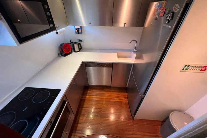 Cİca Sultan Yacht Photos Pics Modern kitchen in 2014 Ark Yat 24M yacht with sleek appliances and wooden flooring.