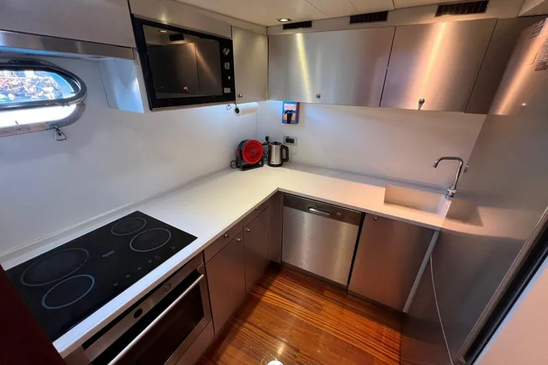 Cİca Sultan Yacht Photos Pics Modern kitchen in 2014 Ark Yat 24M yacht with sleek appliances and wooden flooring.