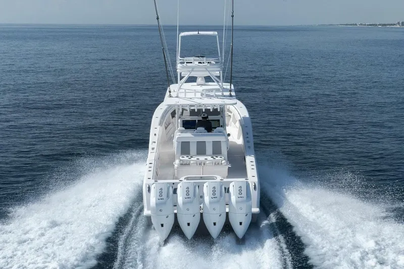 Good Times Yacht Photos Pics 2020 Invincible 42' Open Fisherman boat cruising on open water, rear view.