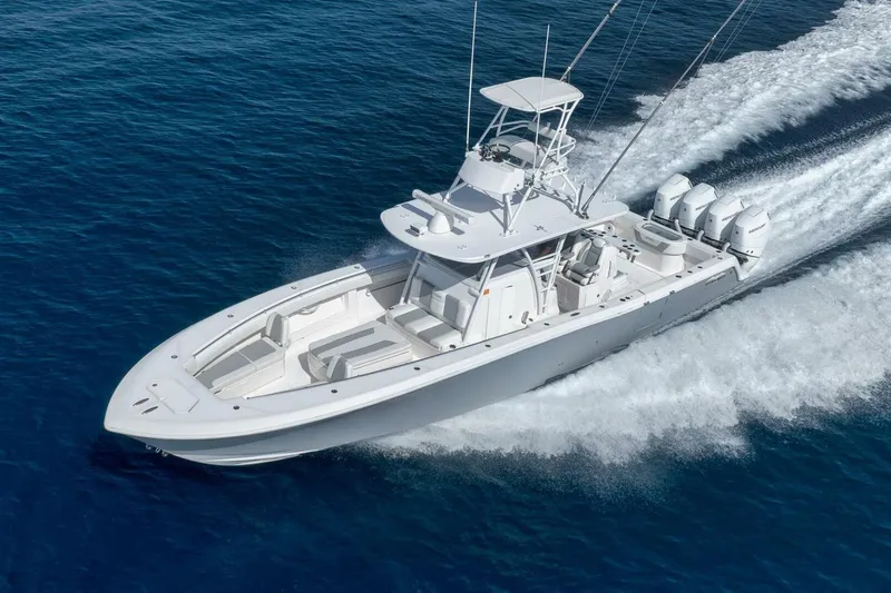 Good Times Yacht Photos Pics 2020 Invincible 42' Open Fisherman boat cruising on blue ocean waters.